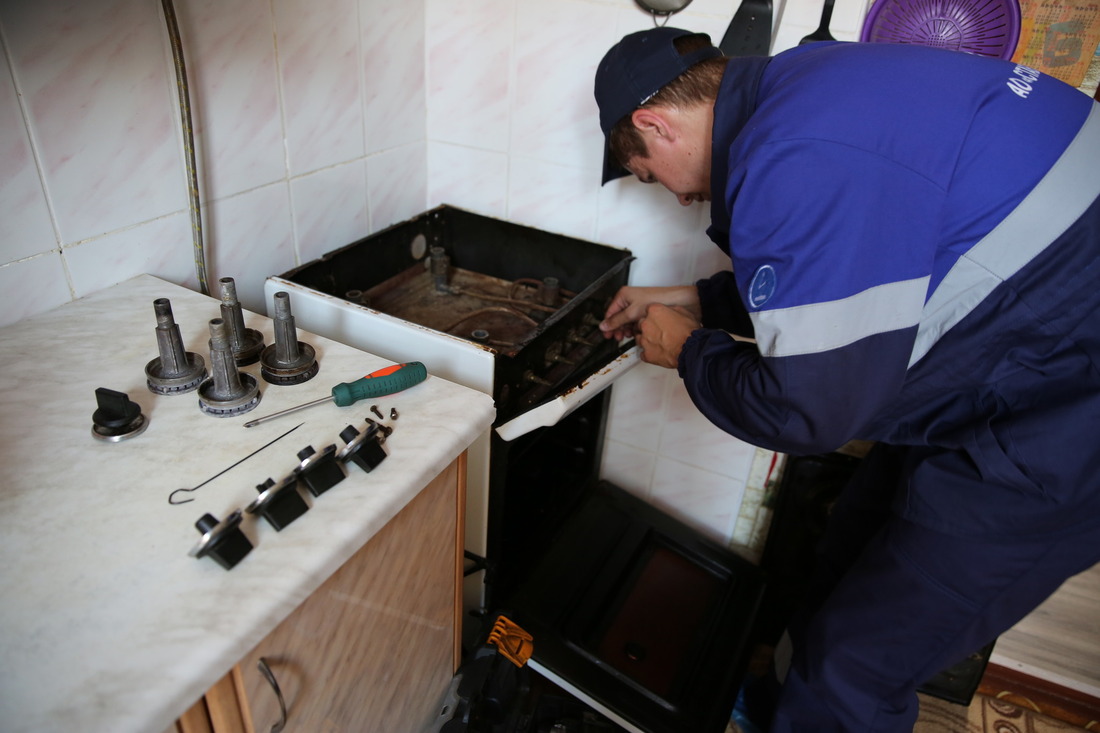 специалист проводит техническое обслуживание газового оборудования